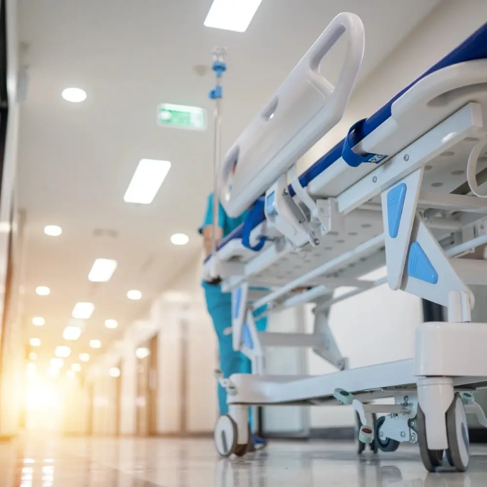 Hospital bed being rolled down a hall