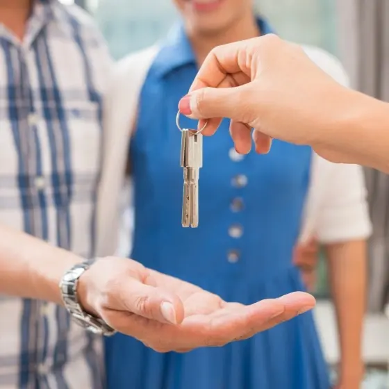 Picture of keys being handed to another person