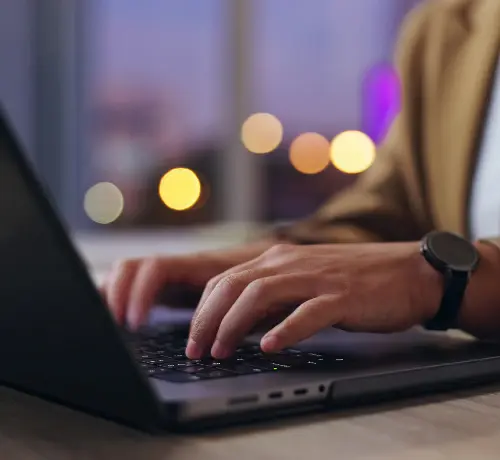 Person writing on a laptop
