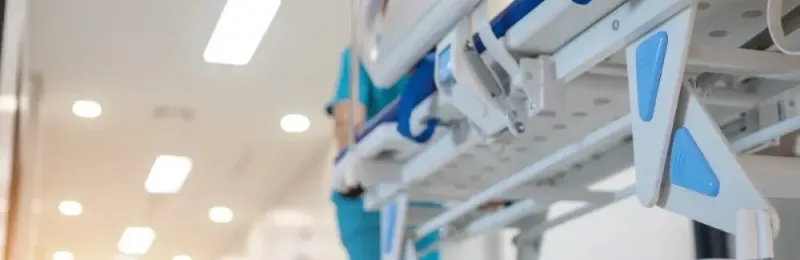 Hospital bed being rolled down a hall