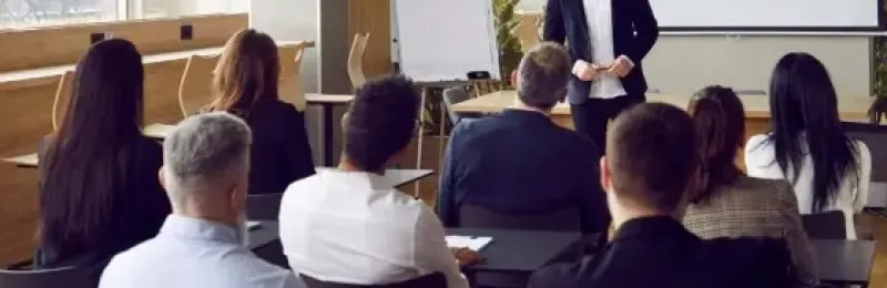 A picture of a business man speaking at a conference