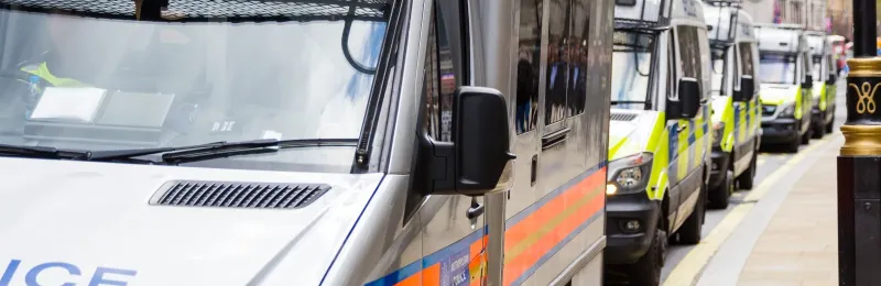 Police Vans Parked by the Side of the Road