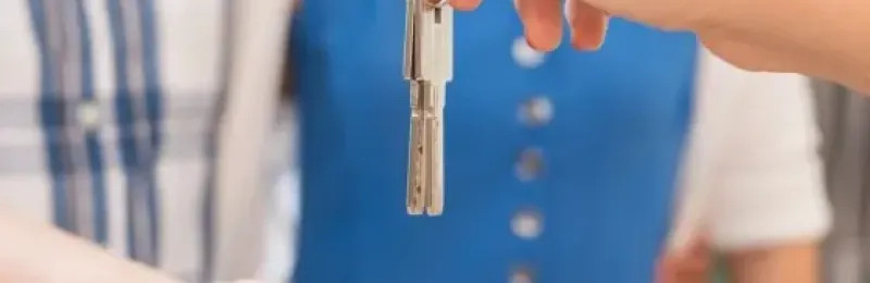 Picture of keys being handed to another person